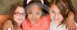 Three young girls smiling together